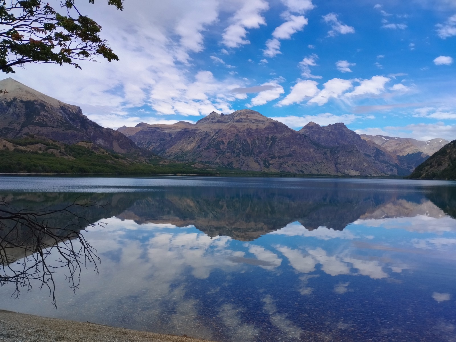 Reflejo de montañas y nubes sobre un lago patagónico